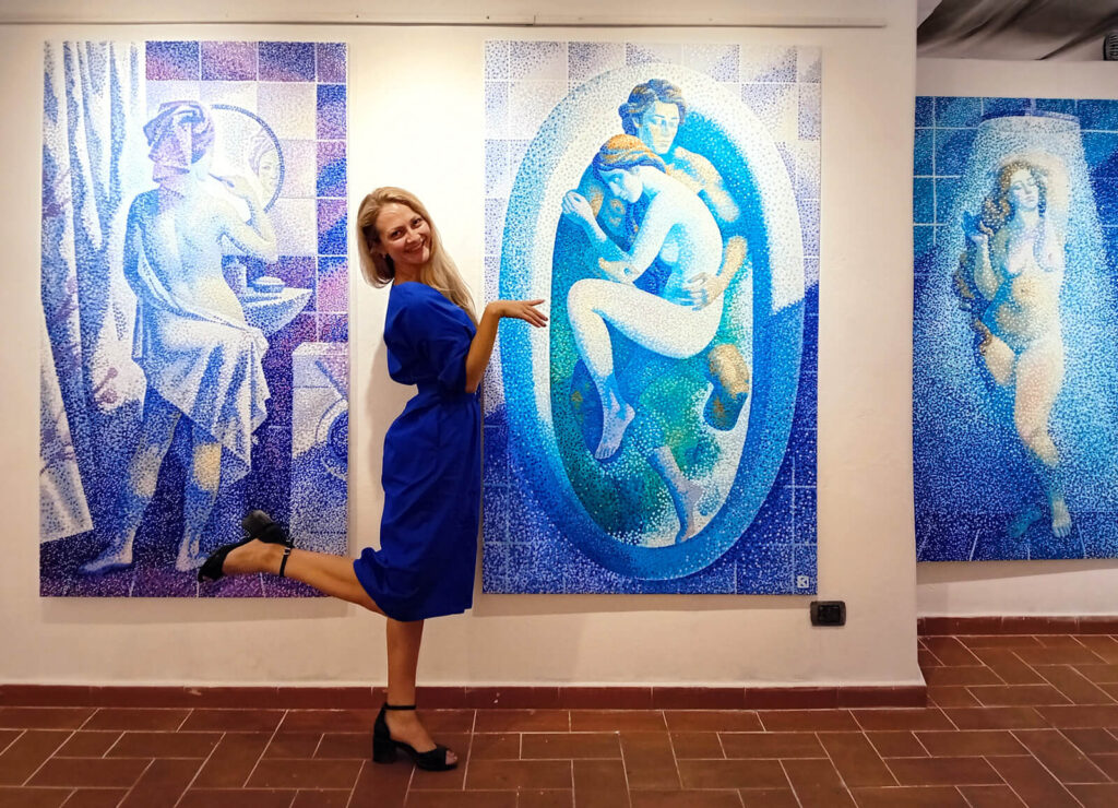 Artist Kristina Korò at the exibition with pieces of the project "particle / pixel=