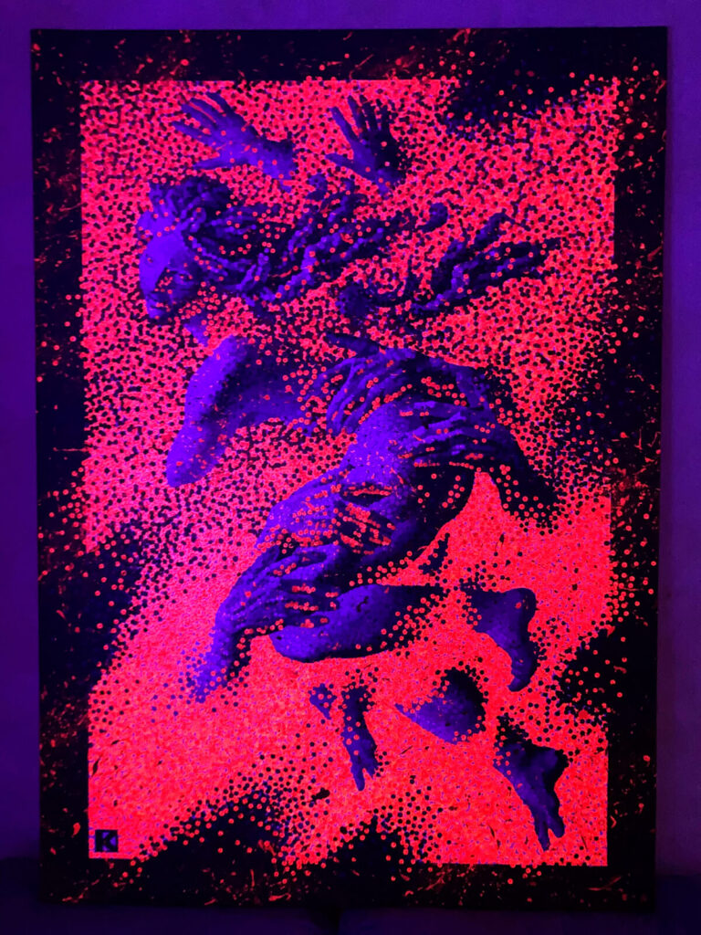 A dynamic pointillist artwork shows overlapping grayscale human figures twisting and reaching across a vivid red background. Multiple disembodied hands grasp and push the bodies, creating a sense of motion, tension, and possession. The surface is built from dense, raised dots, giving the acrylic composition a tactile, high-relief texture. Under UL light the grey gets darker and the red is lightened